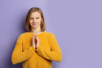 portrait of young caucasian funny girl conceiving something, look tempting isolated over purple...