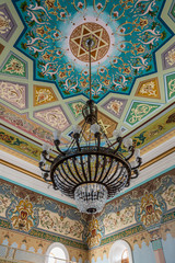 A large decorative chandelier hangs from the ceiling in the old synagogue on the Boris Gaponov street in the old part of Kutaisi in Georgia, in the morning sun
