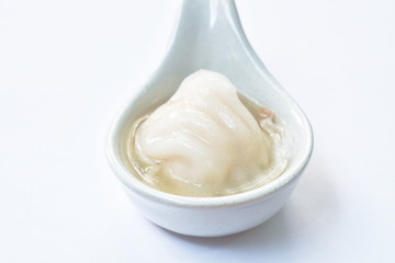 Ha Kao or white dumpling stuffed mashed shrimp and pork dressing soup on spoon