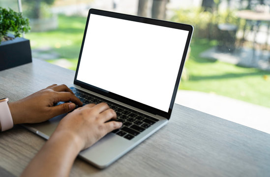 Mockup of a businessman using laptop computer white screen mockup template with clipping path.