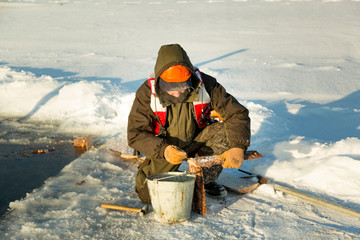 Worker collects formwork for the ice hole