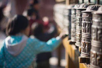 Children spinning  prayer wheels in kathmandu, Nepal