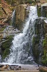 Fototapeta premium Skakalo waterfall in the Carpathian mountains surrounded by forest on a spring sunny day