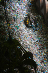 Reception hopper at a large recycling plant. Orange peel grab buckets loaded waste on subsequent processes, sorting, recycling, disposal or incineration.