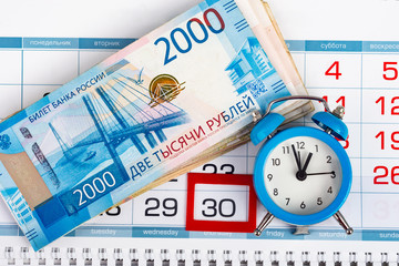 Calendar with a dedicated 30 number, a big pack of Russian money and a clock