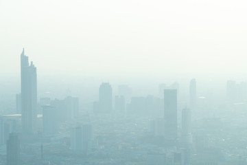 Obraz premium Concept of Pollution PM2.5 Unhealthy air pollution dust. Toxic haze in the city. Photos in the capital on a skyscraper.