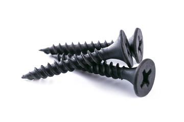 Group of new metal black screws isolated on a white background in close-up.