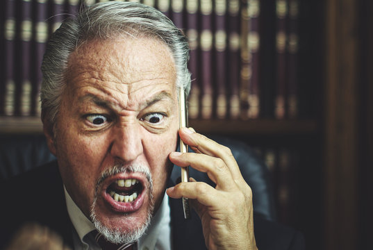 Very Angry Lawyer Talking On The Phone In His Studio