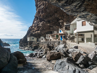 Cueva de Candelaria, Pirate cave Poris de Candelaria, small hidden fisherman village with white and blue houses, tourist attraction near Tijarafe, La Palma, Canary islands, Spain © Kristyna