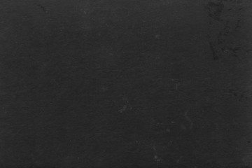 Cardboard black abstract texture close-up. Dark old paper background. Grunge concrete wall. Vintage blank wallpaper.