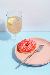 Various sweets, doughnuts, bagels, muffins and drinks on a multi-colored background. Bright colors, the concept of the holiday.