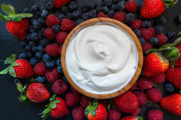 Greek yogurt in bowl with spoons,Healthy breakfast with Fresh greek yogurt, muesli and berries on...