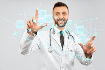 Smiling doctor touching virtual 3D icon.