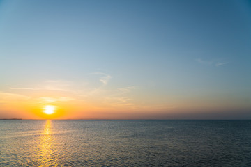 Naklejka na ściany i meble sunset sky in the evening over sea