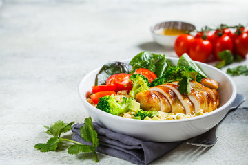 Balanced food concept. Chicken, broccoli and quinoa salad in white bowl, gray background, copy...