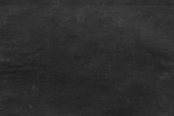 Cardboard black abstract texture close-up. Dark old paper background. Grunge concrete wall. Vintage blank wallpaper.