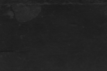 Cardboard black abstract texture close-up. Dark old paper background. Grunge concrete wall. Vintage blank wallpaper.