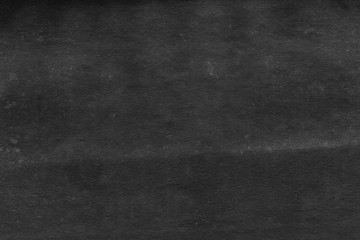 Cardboard black abstract texture close-up. Dark old paper background. Grunge concrete wall. Vintage blank wallpaper.