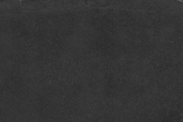 Cardboard black abstract texture close-up. Dark old paper background. Grunge concrete wall. Vintage blank wallpaper.