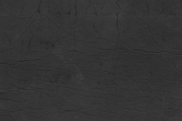 Cardboard black abstract texture close-up. Dark old paper background. Grunge concrete wall. Vintage blank wallpaper.