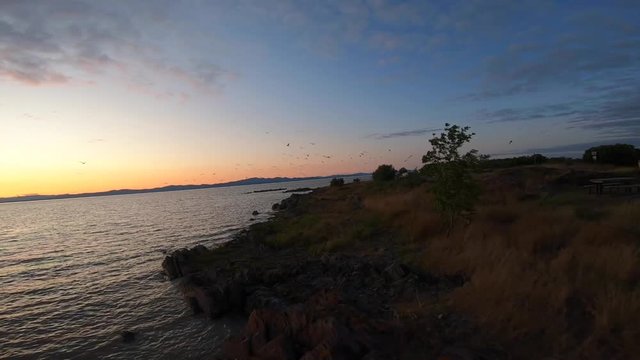 Aerial view drom a drone off a sunset next to St-Lawrence river in Quebec Canada