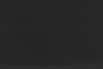 Cardboard black abstract texture close-up. Dark old paper background. Grunge concrete wall. Vintage blank wallpaper.