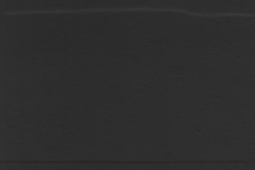 Cardboard black abstract texture close-up. Dark old paper background. Grunge concrete wall. Vintage blank wallpaper.