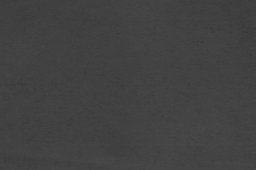 Cardboard black abstract texture close-up. Dark old paper background. Grunge concrete wall. Vintage blank wallpaper.