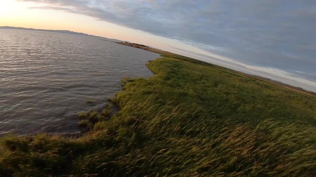 Aerial view drom a drone off a sunset next to St-Lawrence river in Quebec Canada
