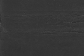 Cardboard black abstract texture close-up. Dark old paper background. Grunge concrete wall. Vintage blank wallpaper.