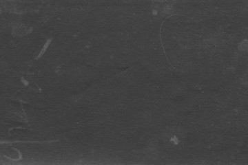 Cardboard black abstract texture close-up. Dark old paper background. Grunge concrete wall. Vintage blank wallpaper.