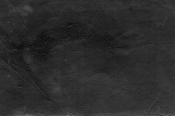 Cardboard black abstract texture close-up. Dark old paper background. Grunge concrete wall. Vintage blank wallpaper.