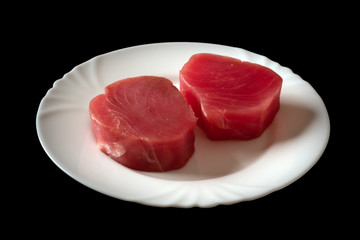 Fresh raw tuna fillet for steak on plate. Tasty fish dinner. Ingredients for cooking