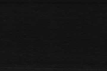 Cardboard black abstract texture close-up. Dark old paper background. Grunge concrete wall. Vintage blank wallpaper.