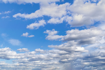 Naklejka na ściany i meble Blue summer sky with bright white cumulus clouds.