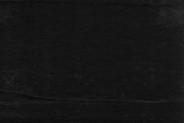 Cardboard black abstract texture close-up. Dark old paper background. Grunge concrete wall. Vintage blank wallpaper.