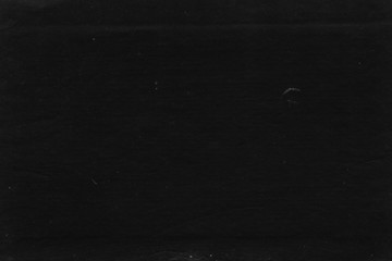 Fototapeta premium Cardboard black abstract texture close-up. Dark old paper background. Grunge concrete wall. Vintage blank wallpaper.