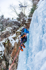 Ice Climbing Man with Crampons on a Frozen Waterfall in the Taschachschlucht (Taschach Valley) in the Pitztal in Austria