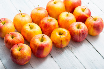 apple fruits in a row, white wooden table background