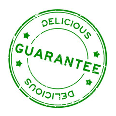 Grunge green guarantee delicious word round rubber seal stamp on white background