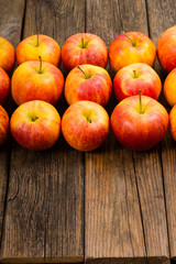 Fototapeta na wymiar apple fruits in a row, old weathered wood table background