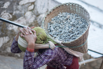 Worker carrying stones on the streets of Kathmandu, Nepal