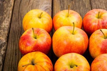 apple fruits in a row, old weathered wood table background