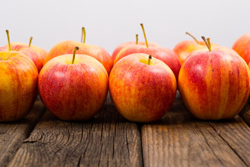 apple fruits in a row, old weathered wood table background