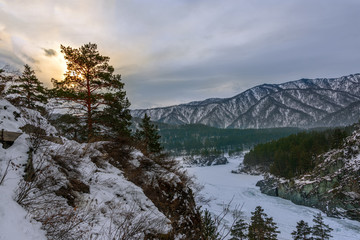 Fototapeta na wymiar Landscape with snow-capped mountains and a freezing mountain river