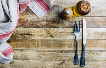 Vintage silverware on rustic wooden background. Top view of kitchen cutlery setting on grunge...