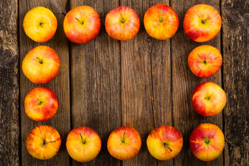 Naklejka na ściany i meble apple fruits frame background, old weathered wood table