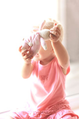 Naklejka premium Baby girl with toy