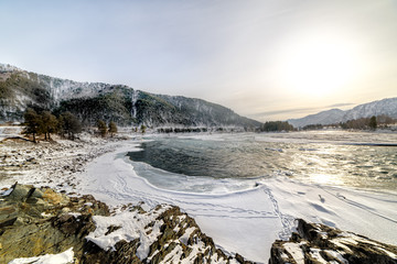 Landscape with snow-capped mountains and mountain river