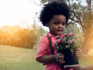 African boy is playing in the garden
